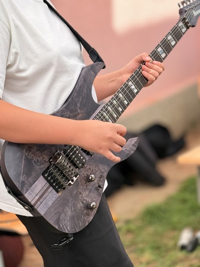 Guitarist playing electric guitar during practice session