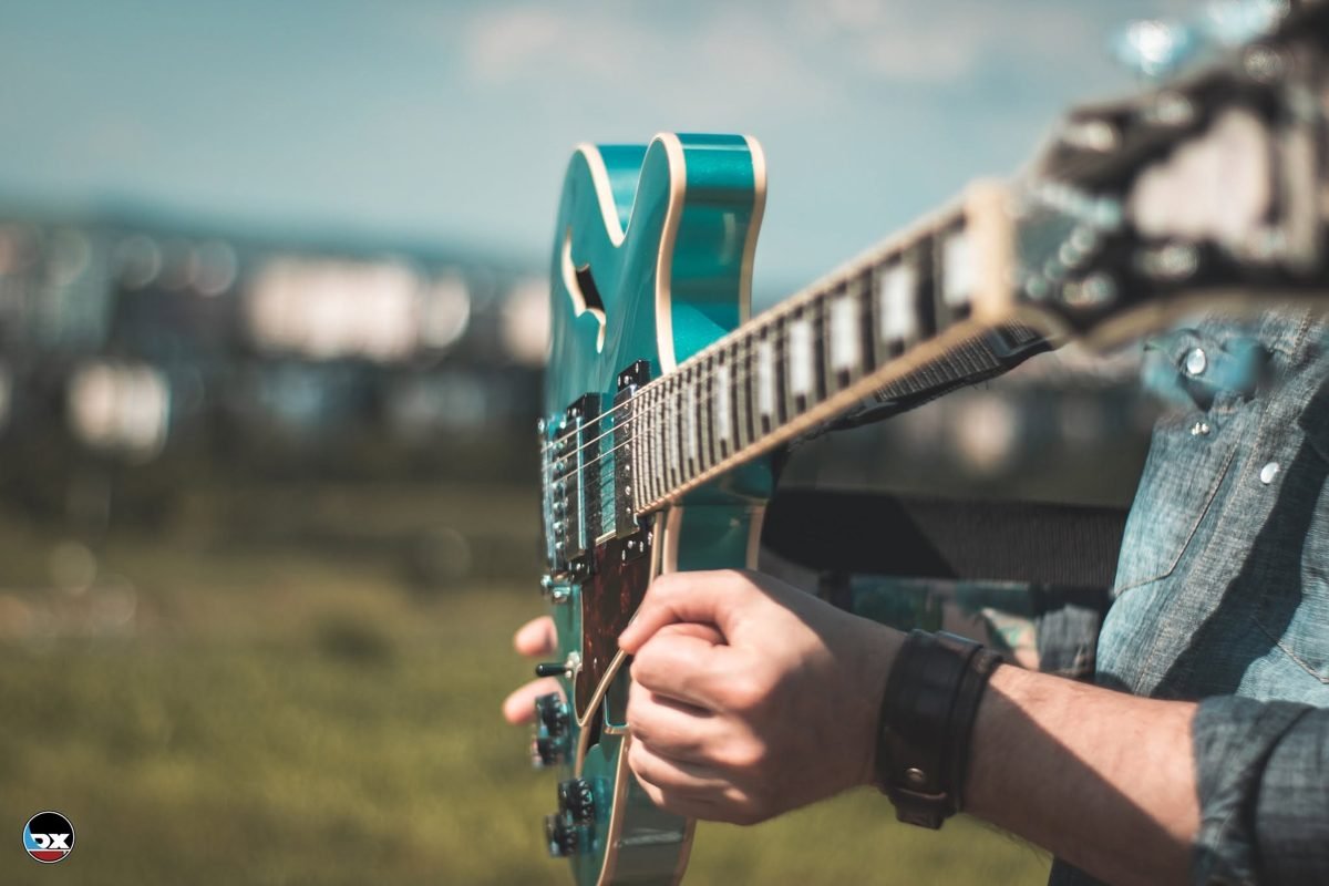 D'Angelico semi-hollow guitar being played outdoors